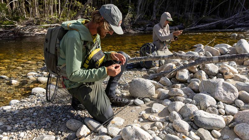Setting up a fly rod on a river bank