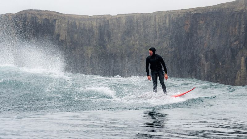  A surfer sticks his tongue out after a ride.